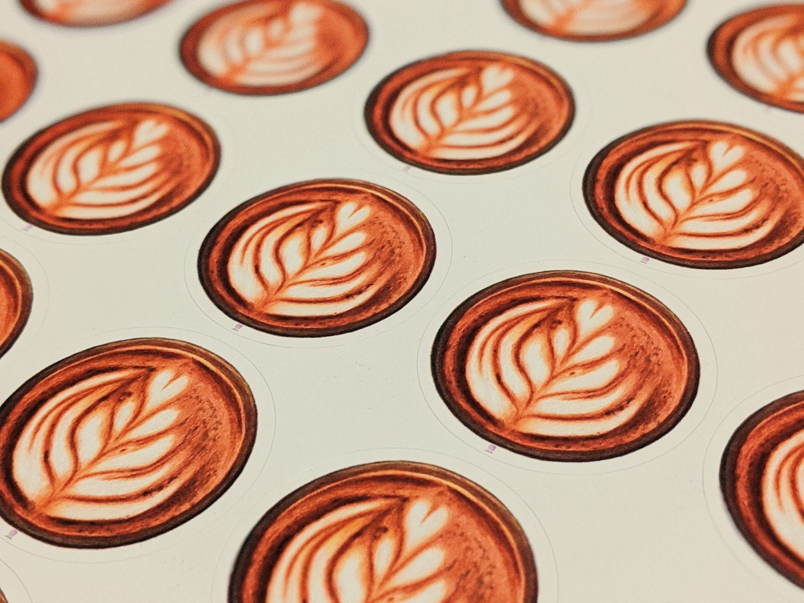 Runde Aufkleber mit Latte-Art-Motiv auf dem Trägerbogen